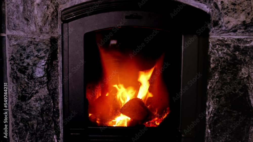 bright orange flame, firewood burns in stove, fireplace in dark room, burning stone and enjoying warmth, cozy winter evening at home concept, relaxing by home fire, energy problem of population bright orange flame, firewood burns in stove, fireplace in dark room, burning stone and enjoying warmth, cozy winter evening at home concept, relaxing by home fire, energy problem of population