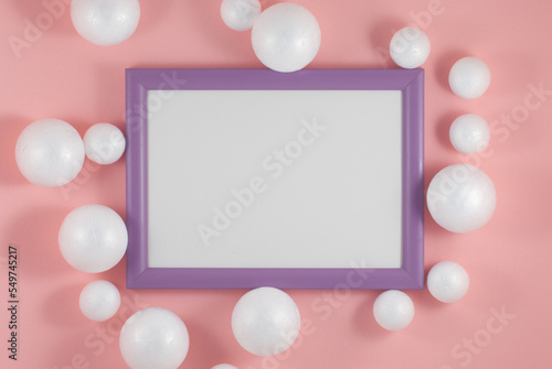 Christmas balls and picture frame on fashion background. Party mockup or invitation. Flat lay © soso