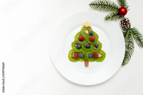 Christmas tree made from kiwi fruits. Flat lay 