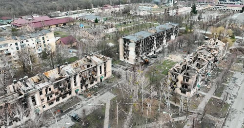 Drone flying over a destroyed district. Roofs of the buildings in the city in ruins - an aerial view with a drone