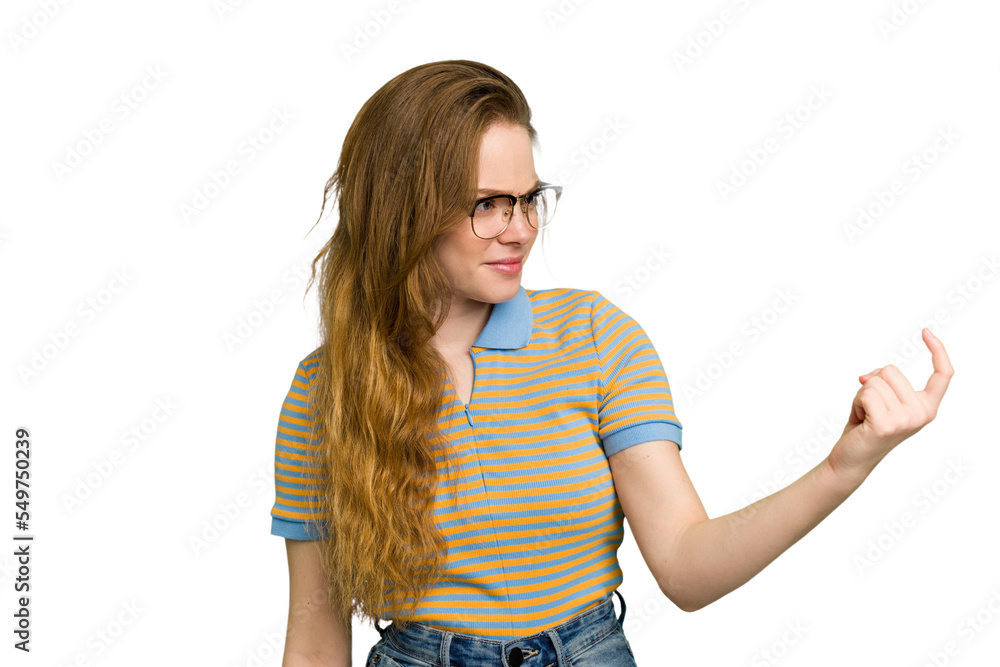 Young caucasian redhead woman isolated pointing with finger at you as if inviting come closer. Young caucasian redhead woman isolated pointing with finger at you as if inviting come closer.