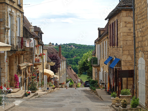 Majestic Bastide of Domme, medieval town of Périgord Noir - Shopping and quiet narrow street with traditional perigordian yellow stone houses, most medieval architecture
 photo