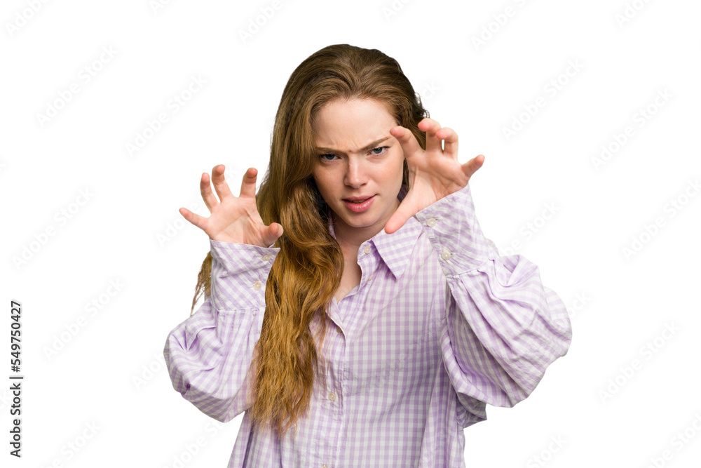 Young caucasian redhead woman isolated showing claws imitating a cat, aggressive gesture. Young caucasian redhead woman isolated showing claws imitating a cat, aggressive gesture.