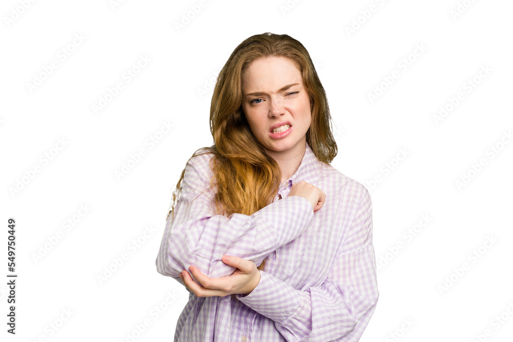 Young caucasian redhead woman isolated massaging elbow, suffering after a bad movement. Young caucasian redhead woman isolated massaging elbow, suffering after a bad movement.