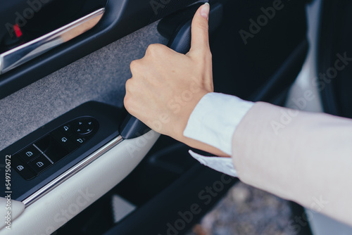 Close-up of young woman's hand closing car doors. © Halfpoint
