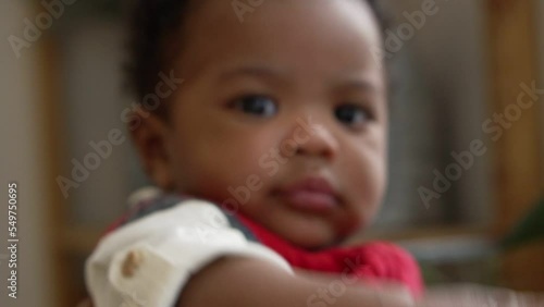 Closeup face of a half Nigeria half Thai is 4-month-old baby newborn son. to African baby infant concept. photo