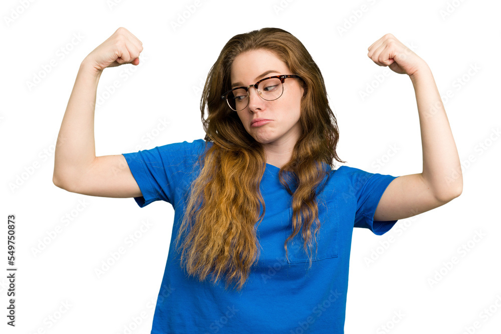 Young caucasian redhead woman isolated showing strength gesture with arms, symbol of feminine power Young caucasian redhead woman isolated showing strength gesture with arms, symbol of feminine power