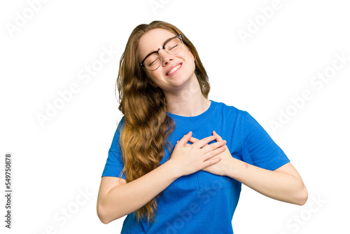 Young caucasian redhead woman isolated laughing keeping hands on heart, concept of happiness.