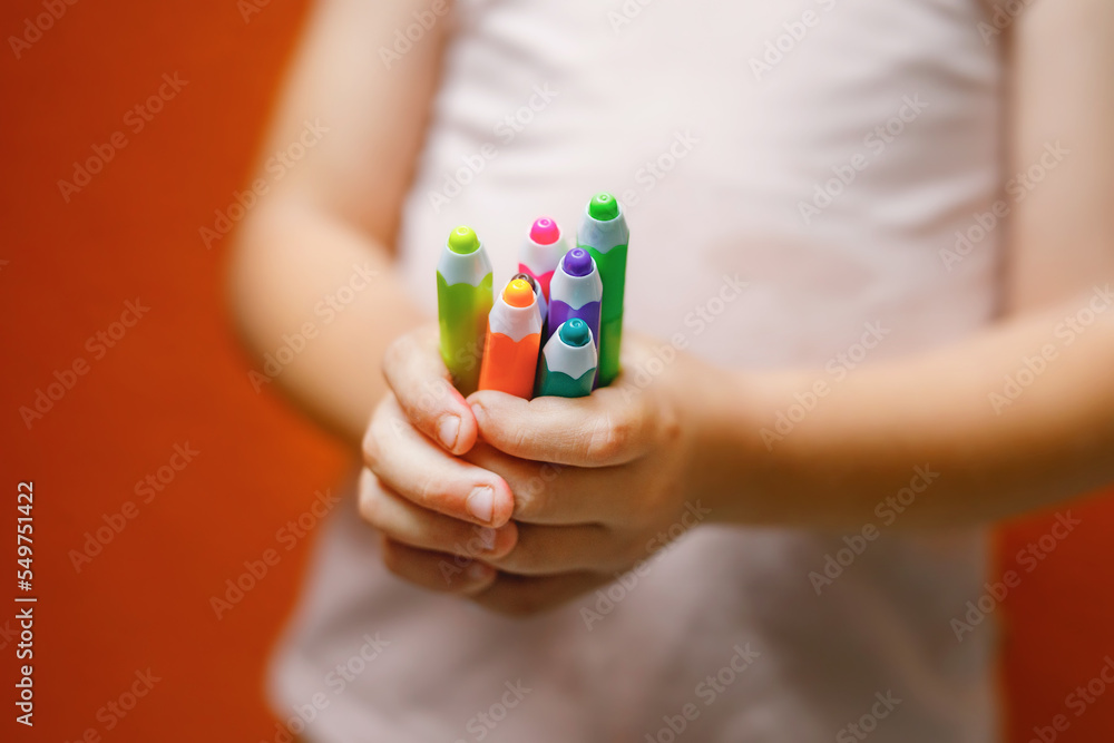 Closeup of hands little preschooler girl holding colorful pencils . Playful child with pencils. Imagination and creativity at school concept. Closeup of hands little preschooler girl holding colorful pencils . Playful child with pencils. Imagination and creativity at school concept.