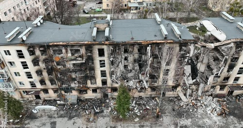 Drone flying over a destroyed district. We can see the roofs of the buildings in the city in ruins - an aerial view with a drone. High quality 4k footage