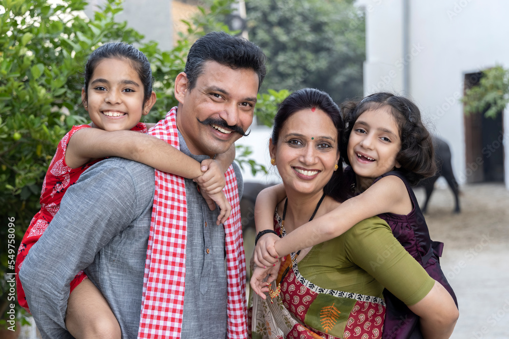Portrait of happy rural indian family looking at camera, little ...