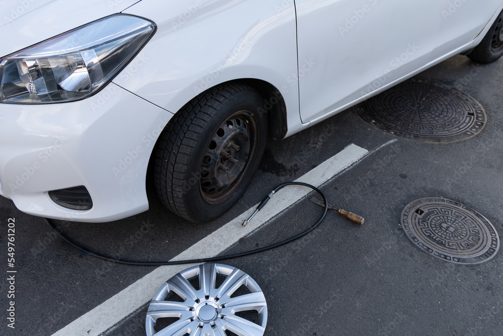  Inflating a tire with air and checking air pressure with gauge pressure in service station. Flat tire concept. Punctured car tire.