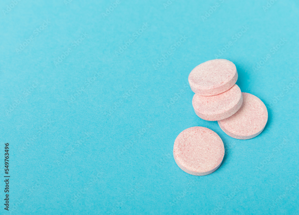 Colored medical pills on a blue background. Vitamins. Health concept. Immunity drug. Space for copy. Space for text. Colored medical pills on a blue background. Vitamins. Health concept. Immunity drug. Space for copy. Space for text.