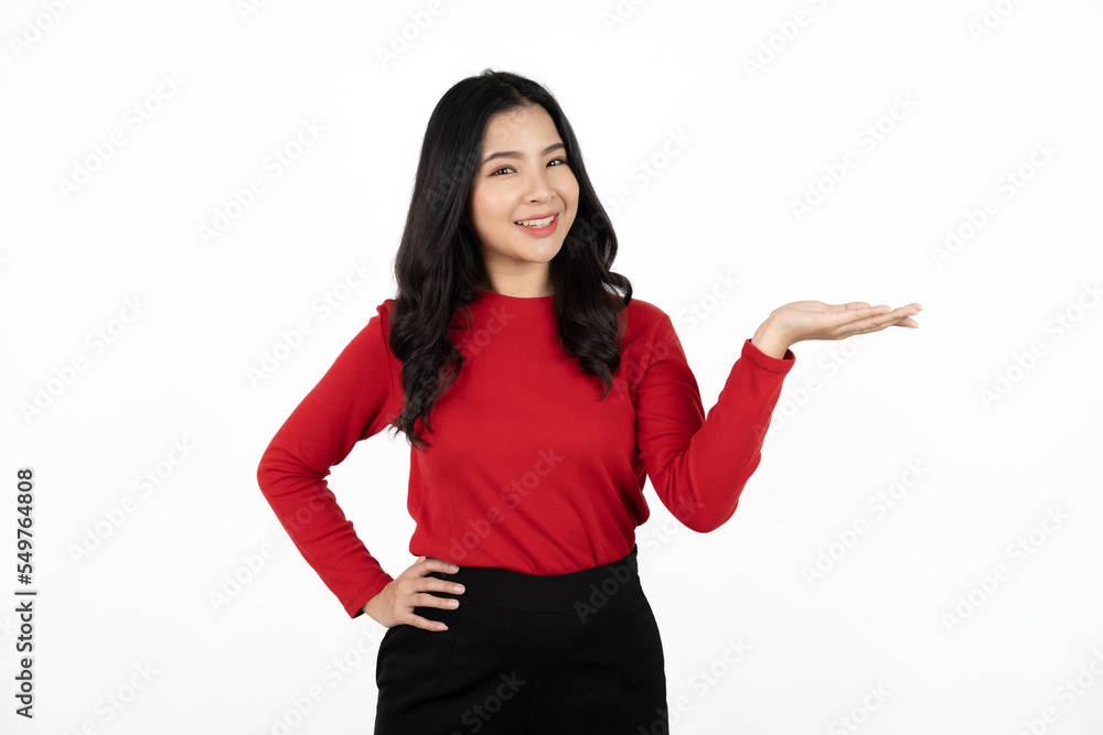 Smiling asian business woman pointing up and looking at the camera over white background. Smiling asian business woman pointing up and looking at the camera over white background.