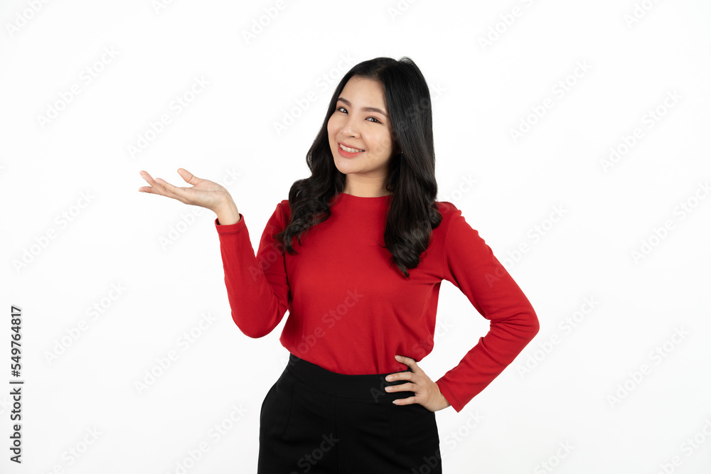 Smiling asian business woman pointing up and looking at the camera over white background. Smiling asian business woman pointing up and looking at the camera over white background.