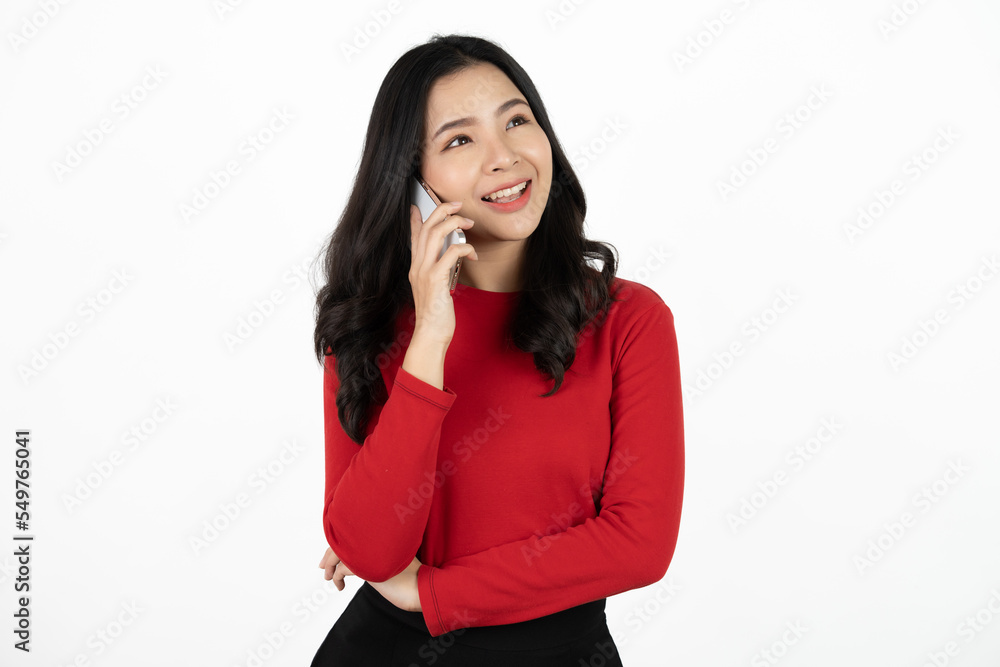 Smiling charming Asian woman uses mobile phone happy texting in social networks addicted to modern technologies isolated over white background. Online communication. Smiling charming Asian woman uses mobile phone happy texting in social networks addicted to modern technologies isolated over white background. Online communication.