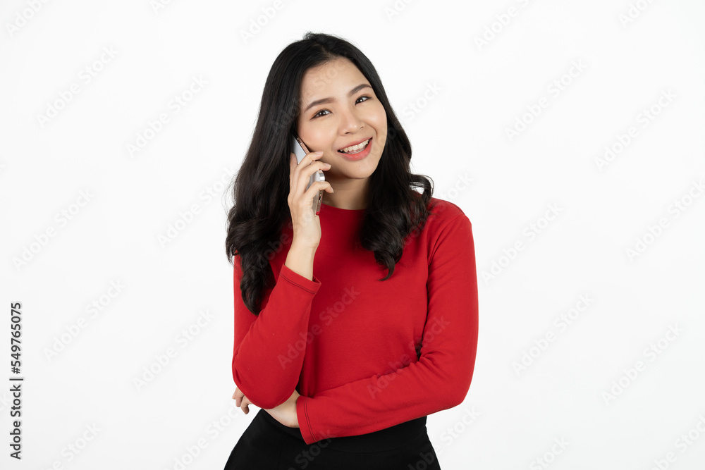 Smiling charming Asian woman uses mobile phone happy texting in social networks addicted to modern technologies isolated over white background. Online communication. Smiling charming Asian woman uses mobile phone happy texting in social networks addicted to modern technologies isolated over white background. Online communication.