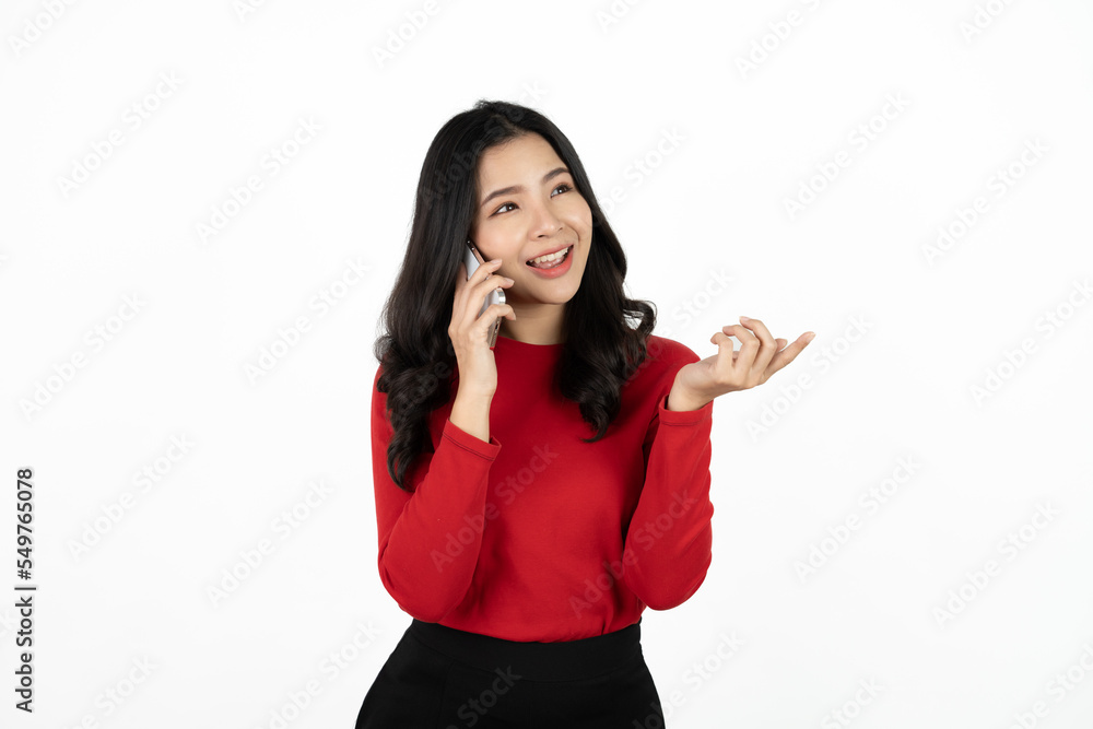 Smiling charming Asian woman uses mobile phone happy texting in social networks addicted to modern technologies isolated over white background. Online communication. Smiling charming Asian woman uses mobile phone happy texting in social networks addicted to modern technologies isolated over white background. Online communication.