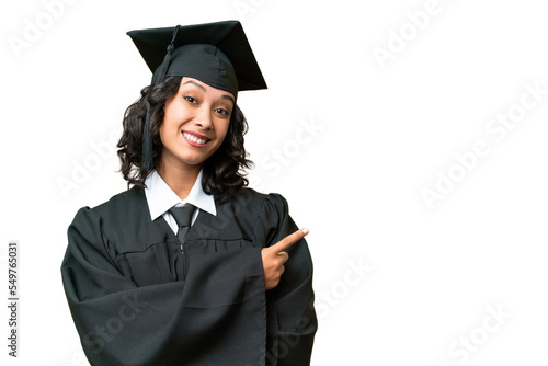 Young university graduate Argentinian woman over isolated background pointing finger to the side photo