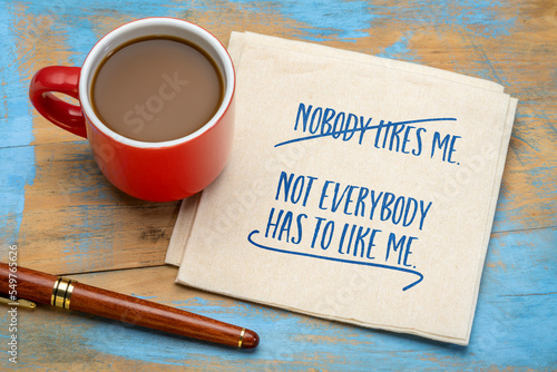 Nobody likes me. Not everybody has to like me. Inspirational handwriting on a napkin with coffee. Social media and personal development concept. photo