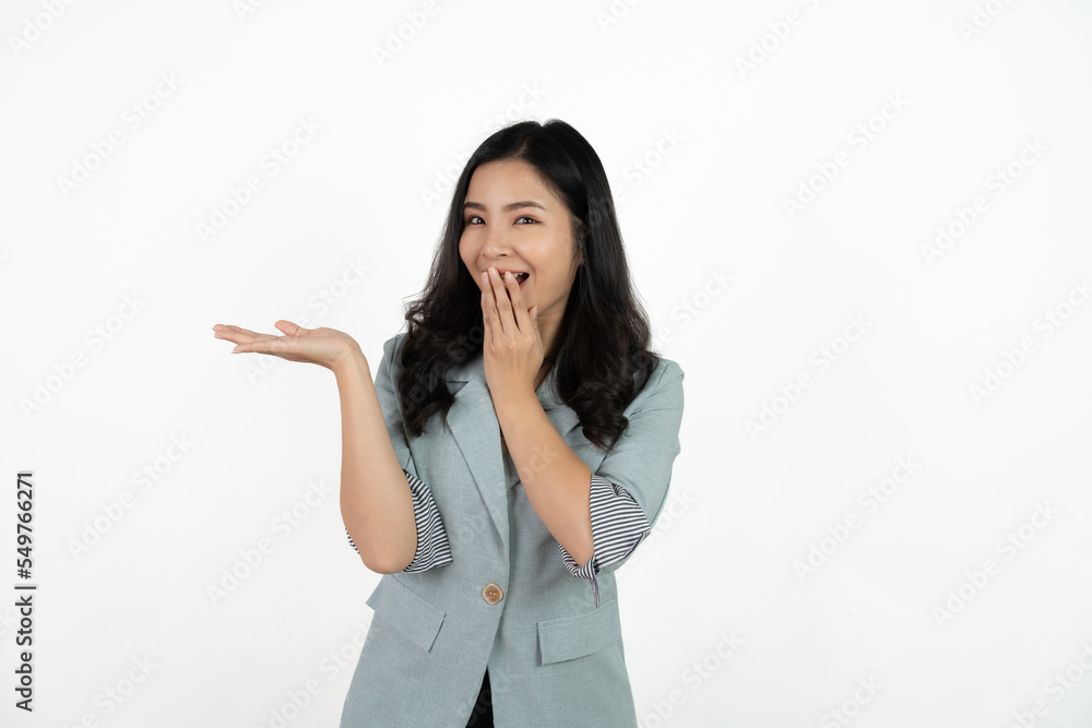 Asian business woman isolated on white background pointing to the side to present a product. Asian business woman isolated on white background pointing to the side to present a product.