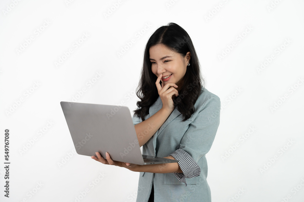 Happy asian business woman holding laptop computer and looking at the camera over white background. Happy asian business woman holding laptop computer and looking at the camera over white background.