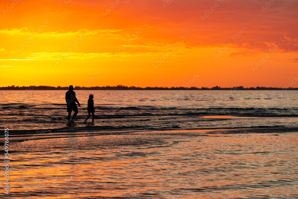 Fototapeta premium beach sunset parent child walking