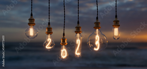 Foto Light bulb New Year background. Edison light bulb. 2023 year.