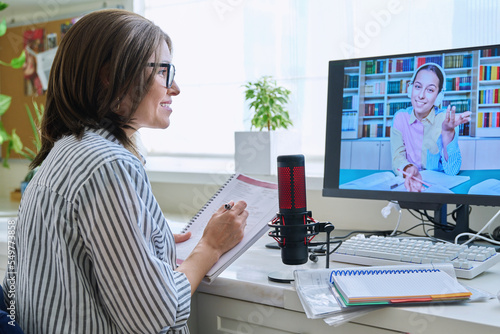 Mature woman talking online with teenage girl using video call