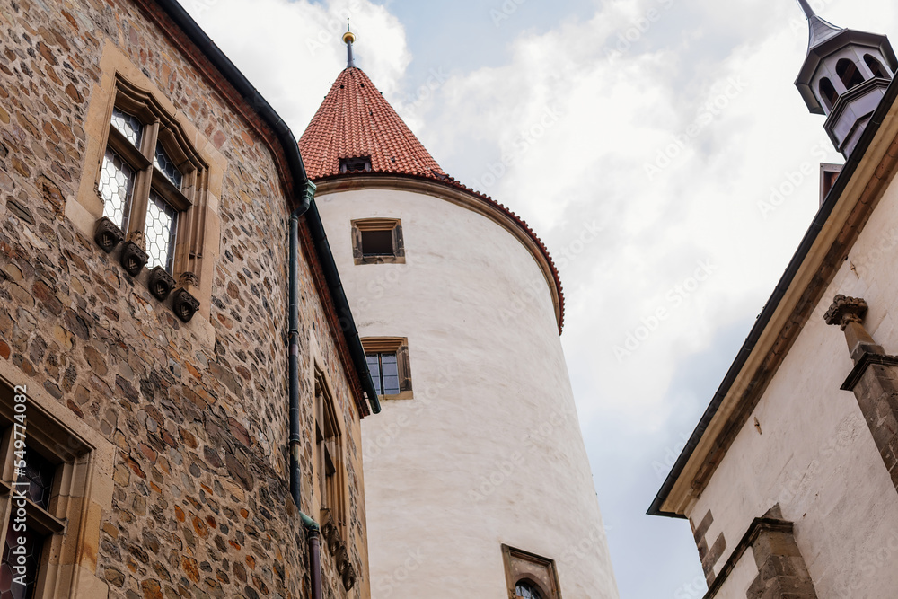 Krivoklat, Czech Republic, 21 August 2022: Courtyard of fortified medieval royal gothic castle, National cultural landmark in summer day, Fortress walls and large round tower