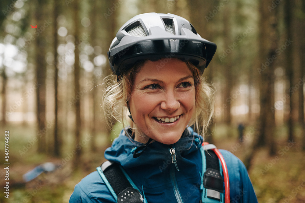 Smiling young woman ready for a mountain bike ride Smiling young woman ready for a mountain bike ride