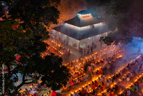 Sonargaon, Bangladesh - 05 November 2022: Aerial view of people praying and worshipping at Sri Bramhachar temple for Hindu fasting festival. photo