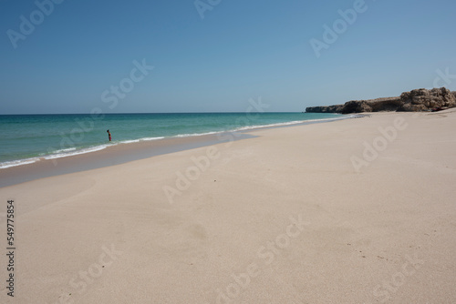 Woman alone at a wild Beach of Ras Al Jinz and going to swim in the ocean, Sultanate of Oman.  © DGPhotography