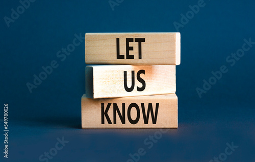 Let us know symbol. Concept words Let us know on wooden blocks on a beautiful grey table grey background. Business and let us know concept. Copy space.