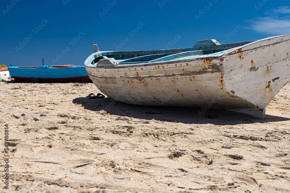 Beautiful view of the boat in the bay of the Mediterranean Sea at low tide on the beach on the island of Djerba, Tunisia Beautiful view of the boat in the bay of the Mediterranean Sea at low tide on the beach on the island of Djerba, Tunisia