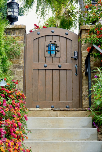 rustic wood garden gate with metal brads and a see-through speakeasy feature photo