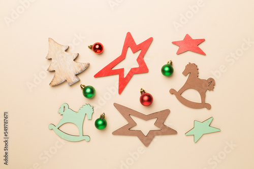 Wooden Christmas toys on color background, top view