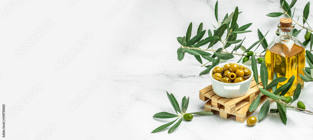 Feta cheese with olives and olive oil sauce in bowl on white background. Traditional Greek homemade cheese. Long banner format. top view