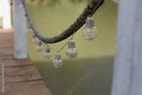 Light bulbs on a string on the pier