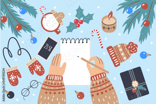 Hands with a notepad and Christmas decor. Setting New Year resolution, goals, plans, to-do list. Writing down thoughts and reflections, summing up the results of the year.