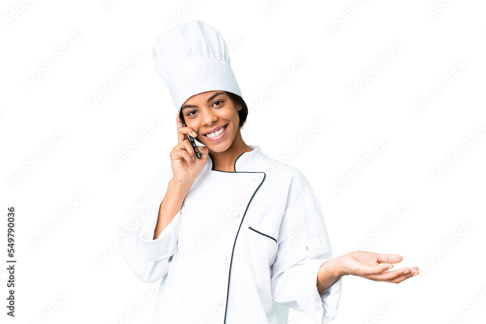 Young African American chef over isolated chroma key background keeping a conversation with the mobile phone with someone Young African American chef over isolated chroma key background keeping a conversation with the mobile phone with someone