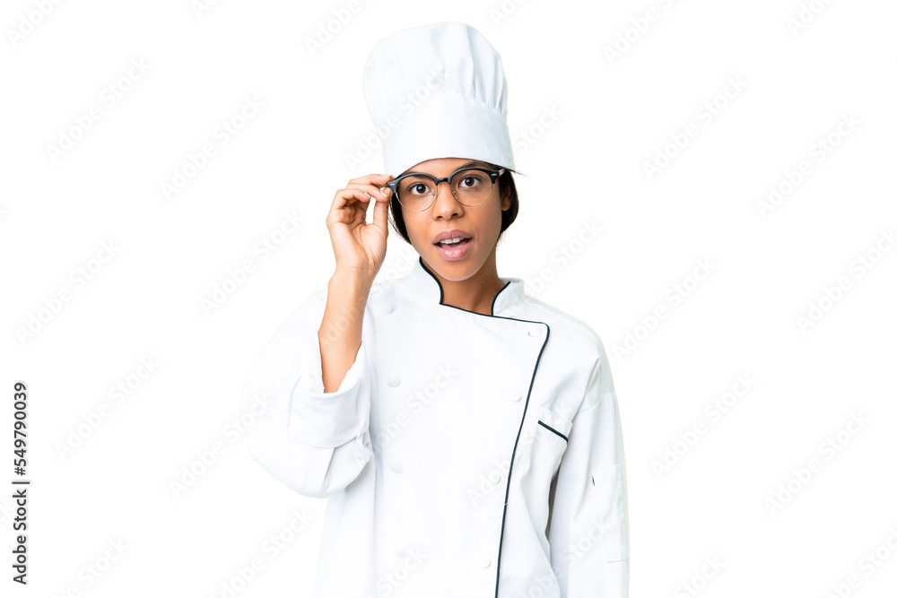 Young African American chef over isolated chroma key background with glasses and surprised Young African American chef over isolated chroma key background with glasses and surprised