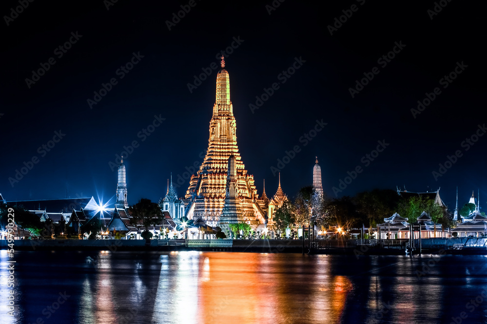 city scape Wat Arun Temple or Temple of dawn at night with Chao Praya River in Bangkok, Thailand