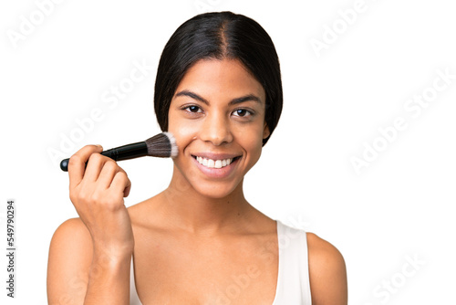 Young woman over over isolated chroma key background holding makeup brush and whit happy expression