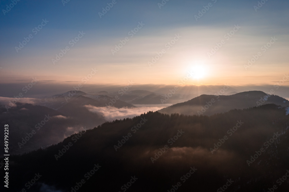 Carpathian peaks in the morning in the clouds, top view, drone footage.