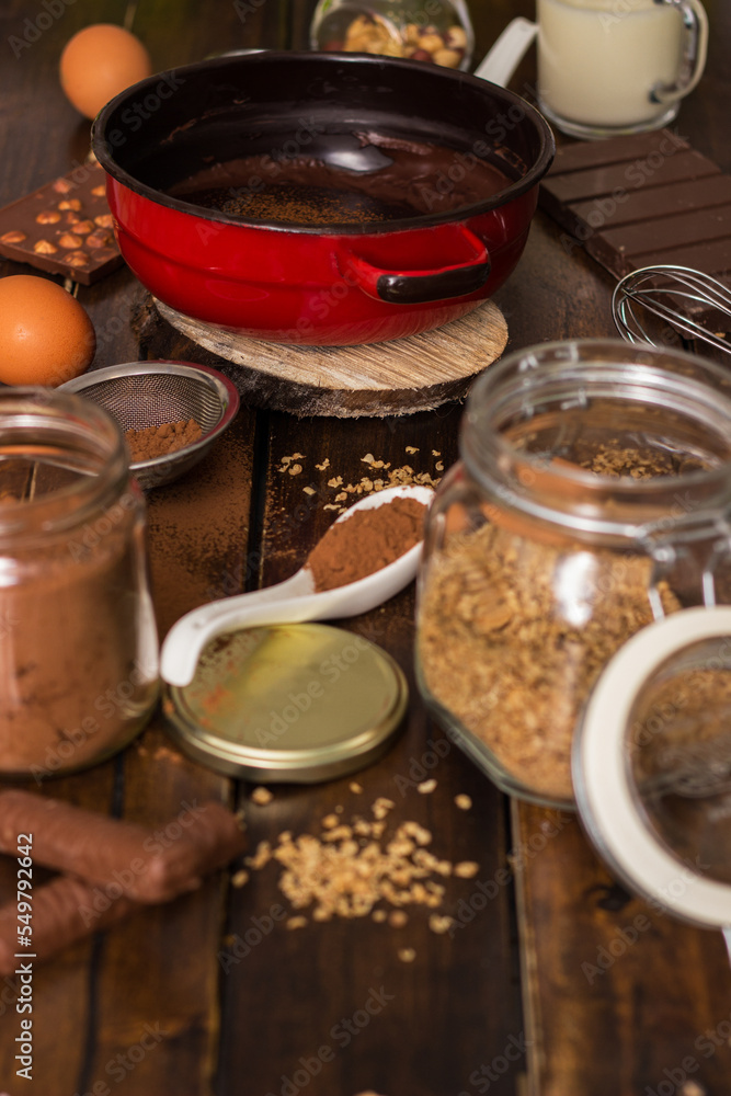 Ingredients for cooking chocolate pastry from above on wooden background