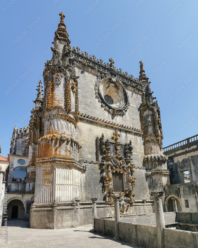 Amazing view at the portuguese gothic facade, manueline facade, with ornamented details, rosacea and iconic window, on Cloister of Saint Barbara, Convent of Christ, Tomar
