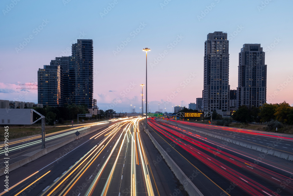 Obraz premium Speed traffic, light trails on freeway at night, long exposure abstract urban background. Toronto West highway 427 southbound. High travel speed effect, dui, careless, dangerous, drunk driving concept