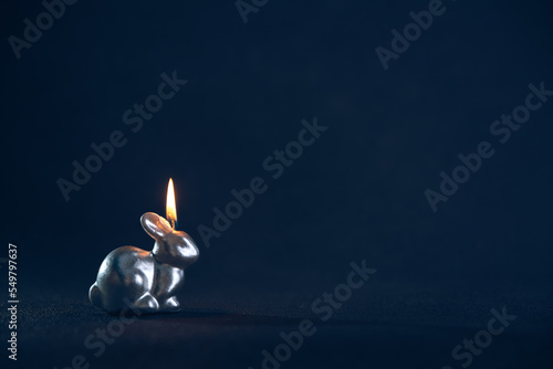 a candle burns in the form of a rabbit, a symbol of 2023