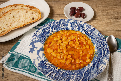 Homemade bean soup with vegetables . Greek bean soup with tomatoes, carrots, celery, and onions. Fasolada photo